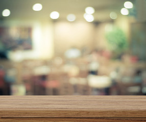 Naklejka na ściany i meble Empty wood table and blurred cafe with bokeh light background