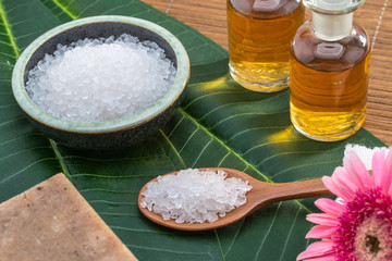 salt, spoon, bowl, oil, on green leaf for health spa material