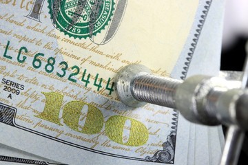 Budget Crisis US Currency one hundred dollar bill in Vise Clamp - Money is Tight Financial Concept