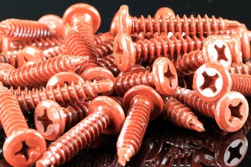 Pile of red metal construction screws