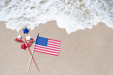 American flag on the sandy beach