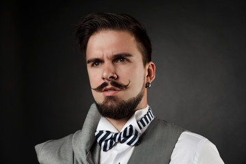 Obraz premium handsome guy with beard and mustache in suit