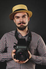 handsome guy with beard holding vintage camera 