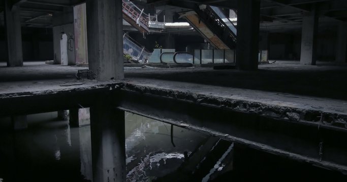 Abandoned concrete building. Creepy interior empty and destroyed shopping mall 