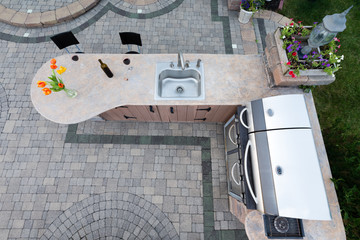 Outdoor summer kitchen with barbecue and sink
