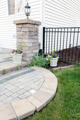 Circular brick step onto an outdoor patio