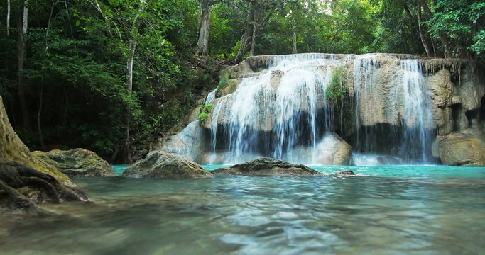 idyllic waterfall and serene environment of wild tropical forest in Thailand