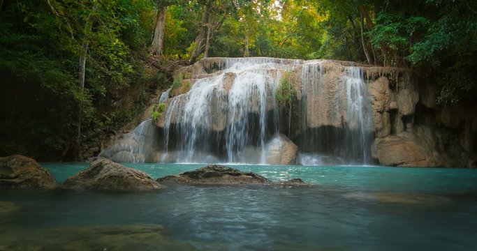 Amazing nature background. Idyllic waterfall in beautiful forest 