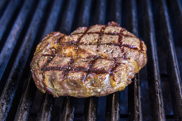 Scotch fillet (rib eye) steak on BBQ