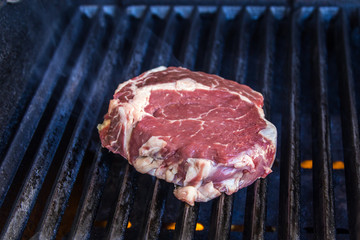 Fresh scotch fillet (rib eye) steak on BBQ