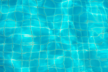 blurred blue water ripple over ceramic floor of swimming pool