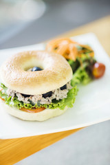 tuna and olive bagel with mixed salad