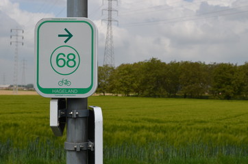 Sign of bicycle network with arrow and number 68