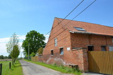Old brick farm house and rural road