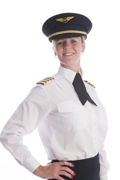 Attractive female airline pilot standing in uniform