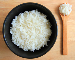 bowl full of rice on wood background