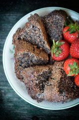 Homemade cake with poppy seeds and almonds on rustic wooden