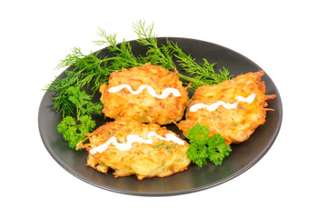 Potato cutlets on the black plate isolated.