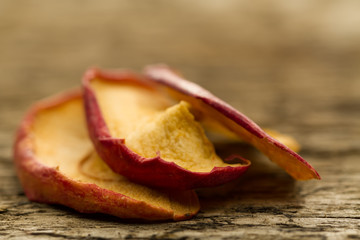 dried apples on the old wooden background. Closeup.