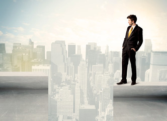 Fototapeta na wymiar Businessman standing on the edge of rooftop