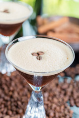 strong cold tonic cocktail with roasted coffee on a table in a