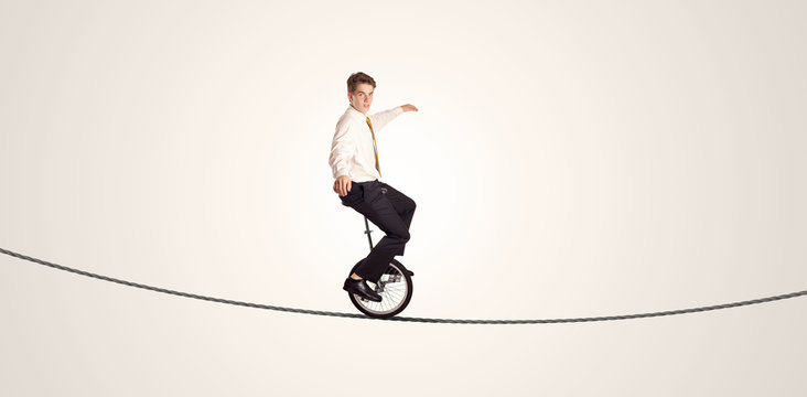 Extreme Business Man Riding Unicycle On A Rope