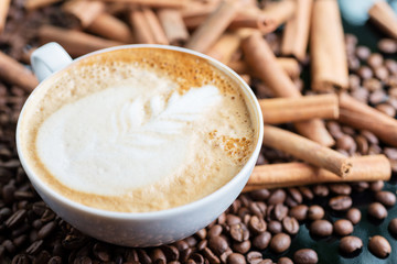 A cup of cappuccino or latte with foam with a creative