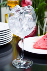 Empty glass filled with ice cubes on a table in the restaurant