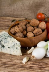 Spring onion and danish blue cheese in front of walnuts