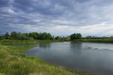 Fototapeta na wymiar Summer landscape with lake and storm clouds