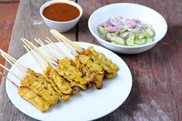 Pork Satay with Peanut Sauce, Wood table background.