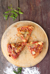 Slice pizza on a wooden background .View from above.