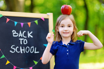 Adorable little schoolgirl is going back to school
