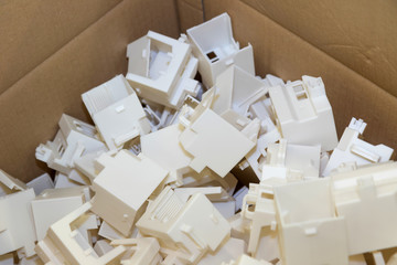 Plastic parts are packed in a cardboard box