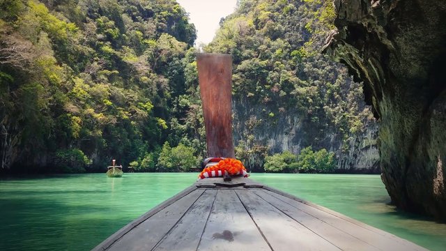 Thailand travel background. Exotic tropical island and wooden boat on sea. 4K