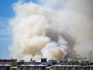Fototapeta na wymiar Burning house causes a big pile of smoke