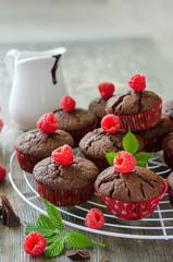 Brown chocolate muffins with raspberries