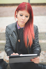 Obraz premium young beautiful red hair venezuelan woman lifestyle using tablet