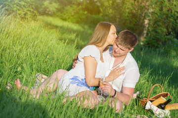 Naklejka na ściany i meble Young couple at a picnic in a city park