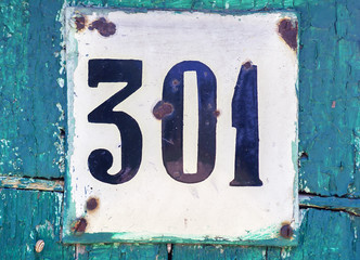 Old scratched metal plate with the number three hundred one