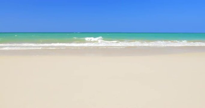 Tropical beach at sunny day with clear blue sky, white sand and sea waves 4K vid