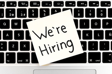 We're hiring note over keyboard notebook, laptop. Job concept. - Powered by Adobe