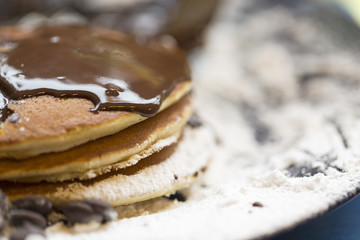 Pancakes with chocolate sauce and icing sugar