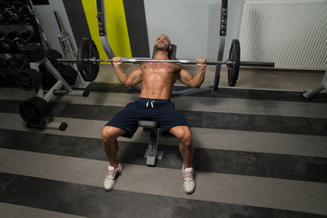 Fototapeta na wymiar Young Man Working Out Chest