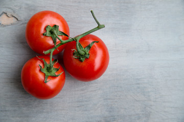 fresh red delicious cherry tomatoes  on an old wooden tabletop 