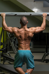 Fototapeta na wymiar Bodybuilder Doing Pull Ups Best Back Exercises