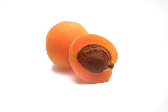 apricot cut in half on white background