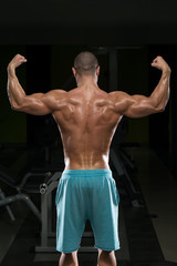 Fototapeta na wymiar Young Man Flexing Muscles
