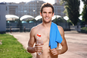 Smiling topless man with water