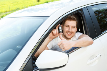 Man thumbing up in car with alarm system
